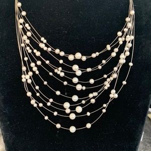Pretty white pearls on metal strands.